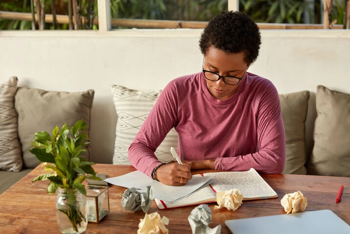 Person writing notes in a notebook