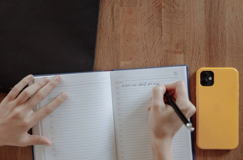 Writer drafting dialogue structure in a notebook